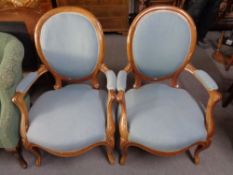 A pair of walnut framed salon armchairs in blue fabric