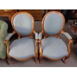 A pair of walnut framed salon armchairs in blue fabric