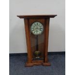 An early 20th century mahogany eight day wall clock, with brass and enamelled dial,