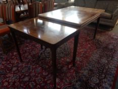 A mid 20th century walnut veneered extending dining table and extending coffee table