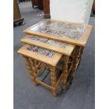 A nest of three blonde oak tiled topped tables