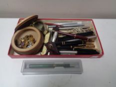 A box of cuff links, pocket knives, assorted pens,