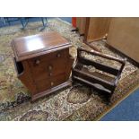 A mahogany storage cabinet fitted with four drawers together with a magazine rack