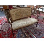 A continental beech framed settee in tapestry fabric