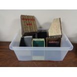 A plastic tray of crate containing storage boxes in the form of books