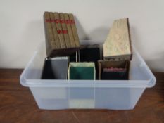A plastic tray of crate containing storage boxes in the form of books