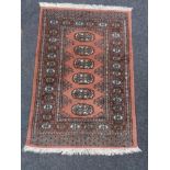 A fringed Persian style hearth rug