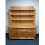 An Ercol elm dresser with cupboards and drawers beneath