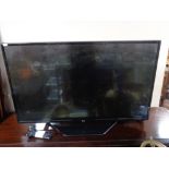 An LG 43 inch lcd tv with lead and remote