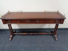 A reproduction mahogany low table fitted with two drawers