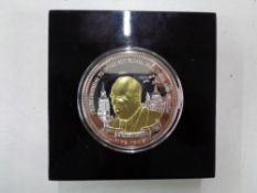 A cased Winston Churchill silver plated commemorative £5 coin