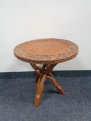 A carved Eastern occasional table