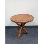 A carved Eastern occasional table