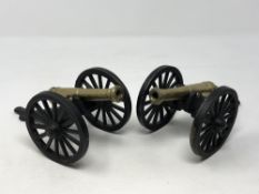 A pair of brass and metal cannons