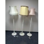 Three early twentieth century painted standard lamps with shades
