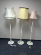 Three early twentieth century painted standard lamps with shades