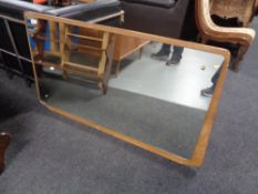 A mid 20th century dressing table mirror on teak board