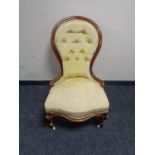 A Victorian button back lady's chair in gold fabric