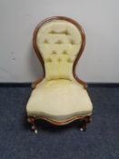 A Victorian button back lady's chair in gold fabric