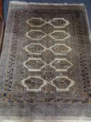 A fringed Eastern rug of geometric design