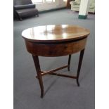 A late 19th century oval inlaid mahogany work table