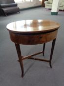 A late 19th century oval inlaid mahogany work table