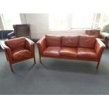 A late 20th century Danish beech framed three seater settee and matching armchair