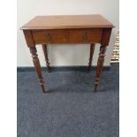 An Edwardian mahogany writing table fitted with two drawers