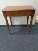 An Edwardian mahogany writing table fitted with two drawers