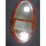 A large oval framed bevelled mirror together with a Danish tiled mirror