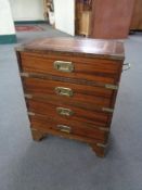 A four drawer leather topped ship's style chest with brass mounts