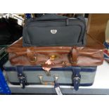 Two luggage cases together with a holdall of lady's handbags