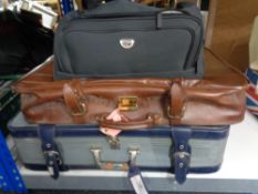 Two luggage cases together with a holdall of lady's handbags