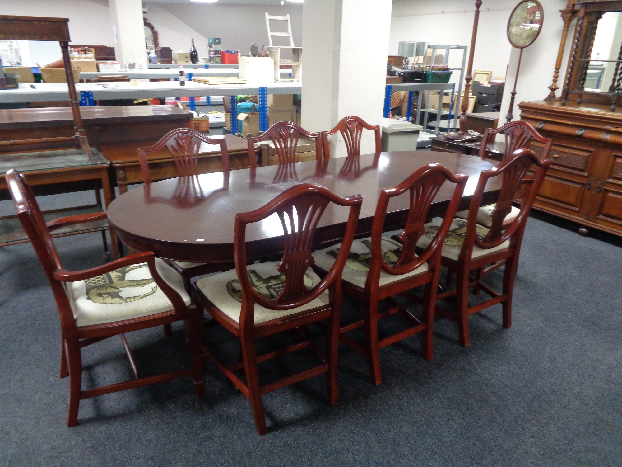 A Beresford & Wicks reproduction dining table with leaf and eight shield back chairs