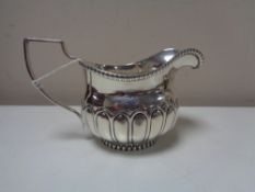 A George III Newcastle silver milk jug, (marks rubbed), John Walton.