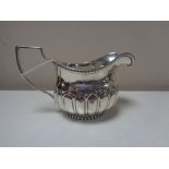 A George III Newcastle silver milk jug, (marks rubbed), John Walton.