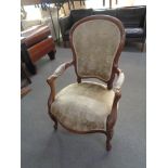 A walnut framed salon armchair in floral brocade