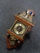 A continental and walnut brass wall clock with pendulum - no weights