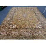 A large machine made floral fringed carpet on gold ground CONDITION REPORT: 402cm