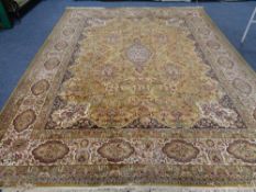 A large machine made floral fringed carpet on gold ground CONDITION REPORT: 402cm