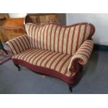 An antique mahogany framed scroll arm settee