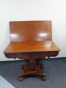 A Victorian mahogany pedestal turnover top table