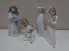 Four Nao figures of children in night dress.