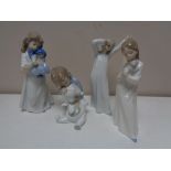 Four Nao figures of children in night dress.