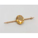 A 15ct gold bar brooch set with a large citrine CONDITION REPORT: 3.