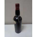 A vintage bottle of port, no label, cap labelled Corney & Barrow,