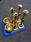 A tray of two heavy pairs of brass candlesticks together with two brass mortars