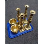 A tray of two heavy pairs of brass candlesticks together with two brass mortars