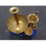 Three heavy brass pestle and mortars and a large brass candle holder