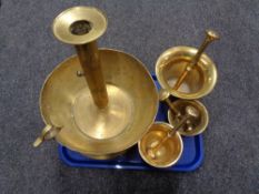 Three heavy brass pestle and mortars and a large brass candle holder